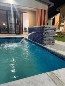 a swimming pool with a water fountain at Lukholo guest house siyabuswa in Siyabuswa