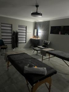 a living room with two tables and a couch at Lukholo guest house siyabuswa in Siyabuswa