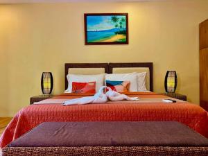a woman laying on top of a bed at Infinity Sands Resort in Siquijor +33 photos
