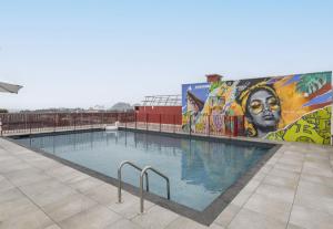 a swimming pool with a mural on the side of a building at B&B HOME La Ciotat in La Ciotat