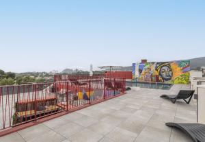 a balcony with a mural on the side of a building at B&B HOME La Ciotat in La Ciotat