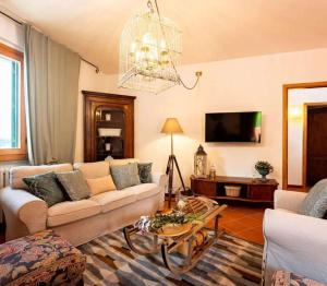 a living room with a couch and a table at Apartment Olearum in Panzano