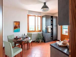 a kitchen with a table and a dining room at Apartment Olearum in Panzano