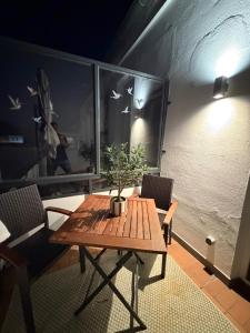 a wooden table and chairs with a potted plant on it at Inselquartier Ratzeburg in Ratzeburg +40 photos