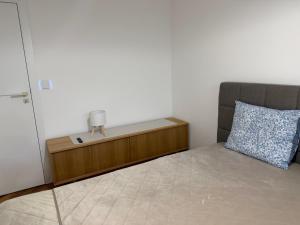 a small bedroom with a bed and a pillow at Studio E9 in Žilina