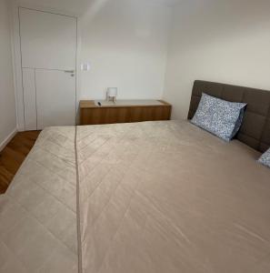 a bedroom with a large bed and a couch at Studio E9 in Žilina