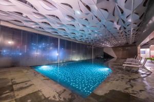 a pool in a room with a ceiling with lights at Premium Suites D'lement Genting Highlands by BYON in Genting Highlands