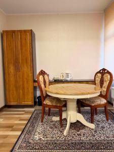 a table and two chairs in a room at Khatanmandal in Dalandzadgad