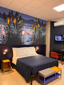 a bedroom with a bed and a painting of flamingos at Magazzino Mediterraneo in Praia a Mare