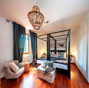 a bedroom with a canopy bed and a chandelier at Apartment Panzano in Panzano