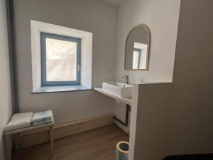 a bathroom with a sink and a mirror at G Opératif in Ornans