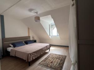 a bedroom with a bed and a window at G Opératif in Ornans