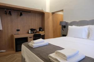 a hotel room with a bed with towels on it at Essence 55 Living in Rhodes Town