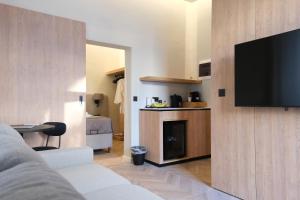 a living room with a flat screen tv on a wall at Essence 55 Living in Rhodes Town