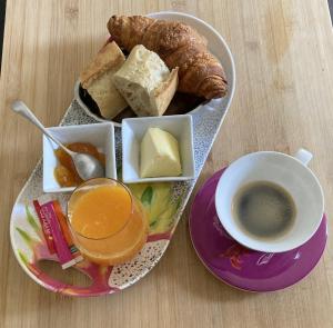 a plate of food with a cup of coffee and bread at Villa Blanche - Suite en Provence in Draguignan