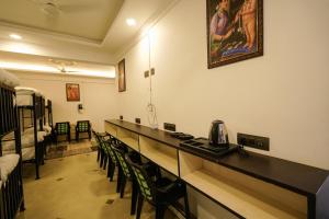 a room with a long table with chairs and a bed at Lumino Winter Castle, Munnar in Pooppara