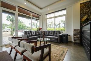 a living room with a couch and a table at Lumino Winter Castle, Munnar in Pooppara