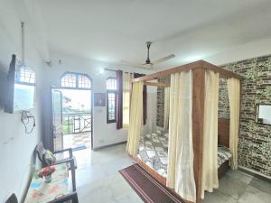 a room with a canopy bed in a room at The Sanmit Stay Kasauli by Splendid Retreat Hotels in Kasauli +28 photos