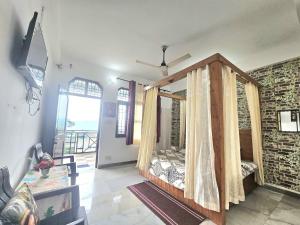 a room with a bed with curtains in it at The Sanmit Stay Kasauli by Splendid Retreat Hotels in Kasauli