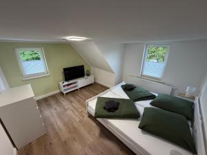 a small bedroom with a bed and a television at Ferienhaus am Johannesberg in Heuthen