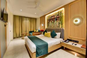 a hotel room with a large bed and a television at Hotel Bhagyalaxmi in Shirdi +111 photos