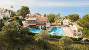 an aerial view of a house with a swimming pool at Aparthotel Ona Aucanada in Port d'Alcudia
