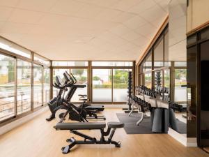 a gym with treadmills and elliptical machines at Aparthotel Ona Aucanada in Port d'Alcudia