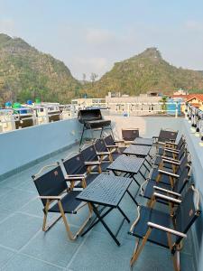a group of chairs sitting on top of a roof at A2 House Cát Bà in Cat Ba