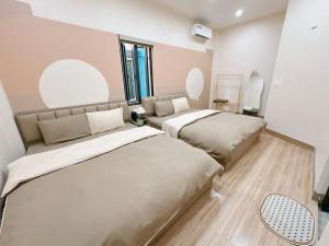 two beds in a room with two mirrors at A2 House Cát Bà in Cat Ba