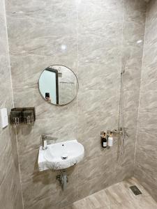 a bathroom with a sink and a mirror at A2 House Cát Bà in Cat Ba