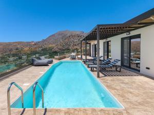a swimming pool on the patio of a house at Rodia Luxury Villa in Plakias