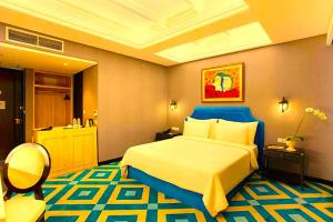 a hotel room with a large bed and a bathroom at Hotel Madhurika Palace in Dhanbād
