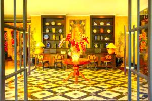 a room with a table with a vase of flowers on it at Hotel Madhurika Palace in Dhanbād