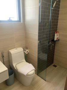 a bathroom with a toilet and a glass shower at ARVO Cam Ranh - Infinity swimming pool in Cam Ranh International Airport +8 photos