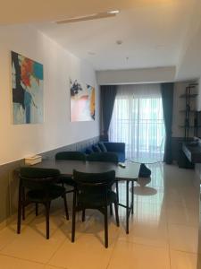 a living room with a table and chairs and a couch at ARVO Cam Ranh - Infinity swimming pool in Cam Ranh International Airport