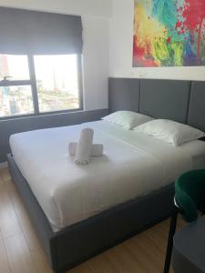a large bed with two towels on top of it at ARVO Cam Ranh - Infinity swimming pool in Cam Ranh International Airport
