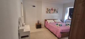 a bedroom with a bed with two stuffed animals on it at Sweet Home in Tolmezzo
