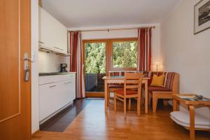 a kitchen and dining room with a table and chairs at Landhaus Rieding in Mühlbach am Hochkönig