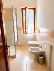 a bathroom with a toilet and a sink at La Scaletta in San Colombano +45 photos