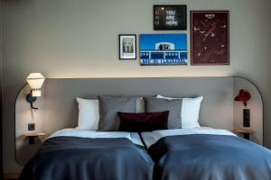 a bedroom with a large bed with blue sheets at Scandic Kødbyen in Copenhagen