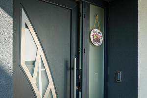 a door with a clock on the side of it at Kuća za odmor BARBARELLA - prostrani 2BR apartman, parking & WiFi in Čakovec