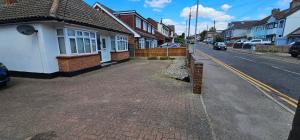 an empty street in a residential neighborhood with houses at Contractors Home from Home in South Benfleet