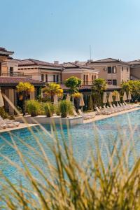 a hotel swimming pool with chairs and umbrellas at Green Life Apartments Sozopol in Sozopol +95 photos