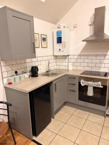 a kitchen with a sink and a counter top at The Old Smithy in Langsett