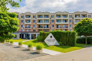 a large building with a sign in front of it at Green Life Sozopol Antares in Sozopol