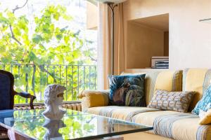 a living room with a couch and a glass table at IseoLakeRental - Nido Belvedere in Fonteno