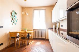 a kitchen with a table and chairs and a window at IseoLakeRental - Nido Belvedere in Fonteno