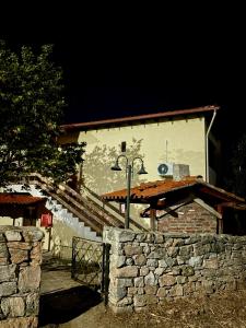 a building with a stone wall in front of it at Blue Horizon Makri in Alexandroupoli