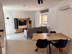 a living room with a table and a couch at Apartamentos San Antonio - GrupoAMI in Ontinyent +28 photos