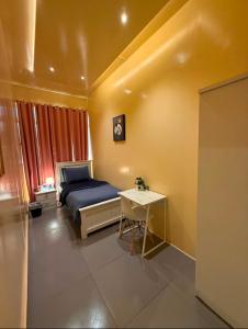 a bedroom with a bed and a table in it at Haven Hub in Abu Dhabi